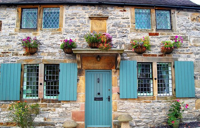 Image of a cottage with blue windows and door.