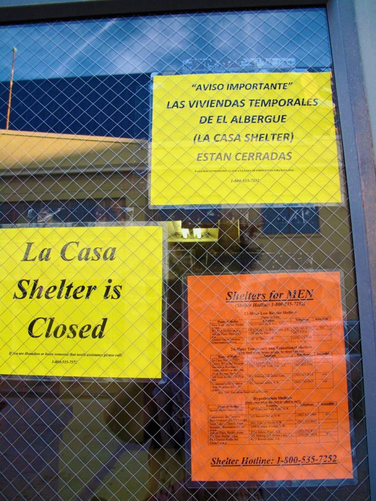 Photo of "closed" signs posted on the doors of the former La Casa transitional shelter.