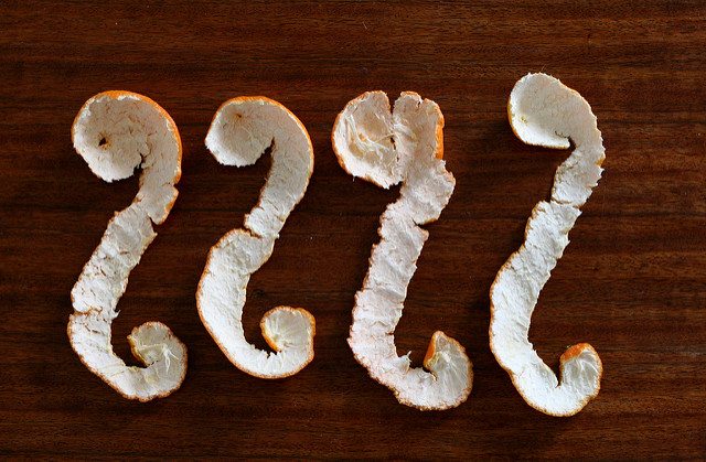 Four orange peels in a line