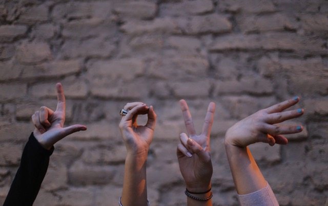 "Love" spelled out using hands.