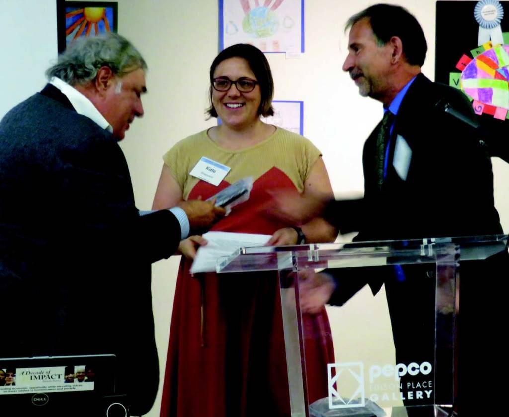 A photograph of Chris Shaw winning the Street Sense Excellence in Journalism Award, alongside Dan Zak, Kavitha Cardoza and Bill O’Leary.