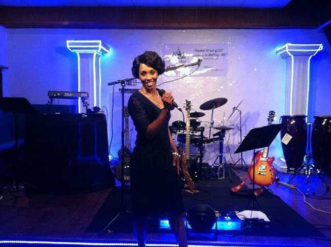 Cassandra on stage performing comedy.