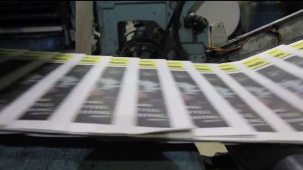 Photo of papers coming out of a press