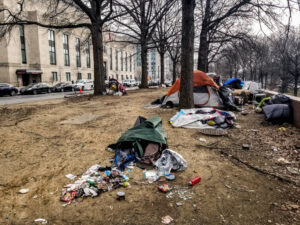 A trash pile near many tents that had been abandoned before the cleanup