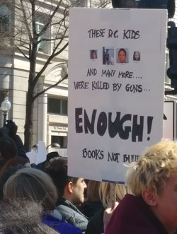 A poster showing several teenagers that died from gun violence in DC in 2018.