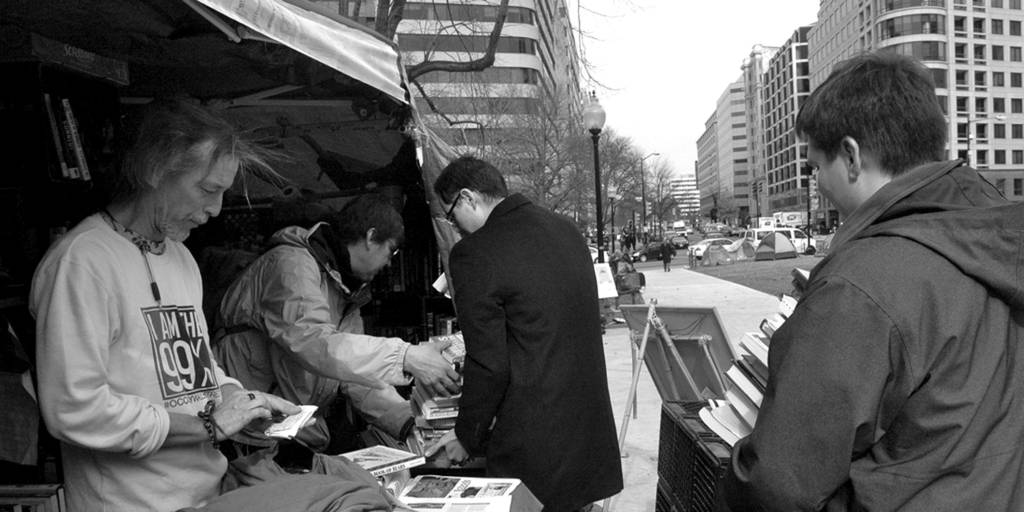 Representatives from Drug Policy Lines donate books to the McPherson Square encampment library.