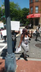 Marchers hold signs and make their way to the headquarters of the Department of Health and Human Services