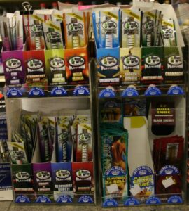 Photo of colorful packages of cigar wraps on display in a store.