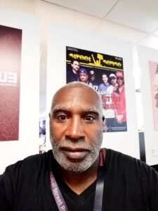 Wendell Williams in front of Street Sense poster
