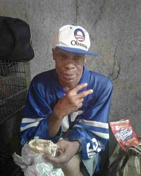 Charles Davis flashes a peace sign while wearing an Obama hat.