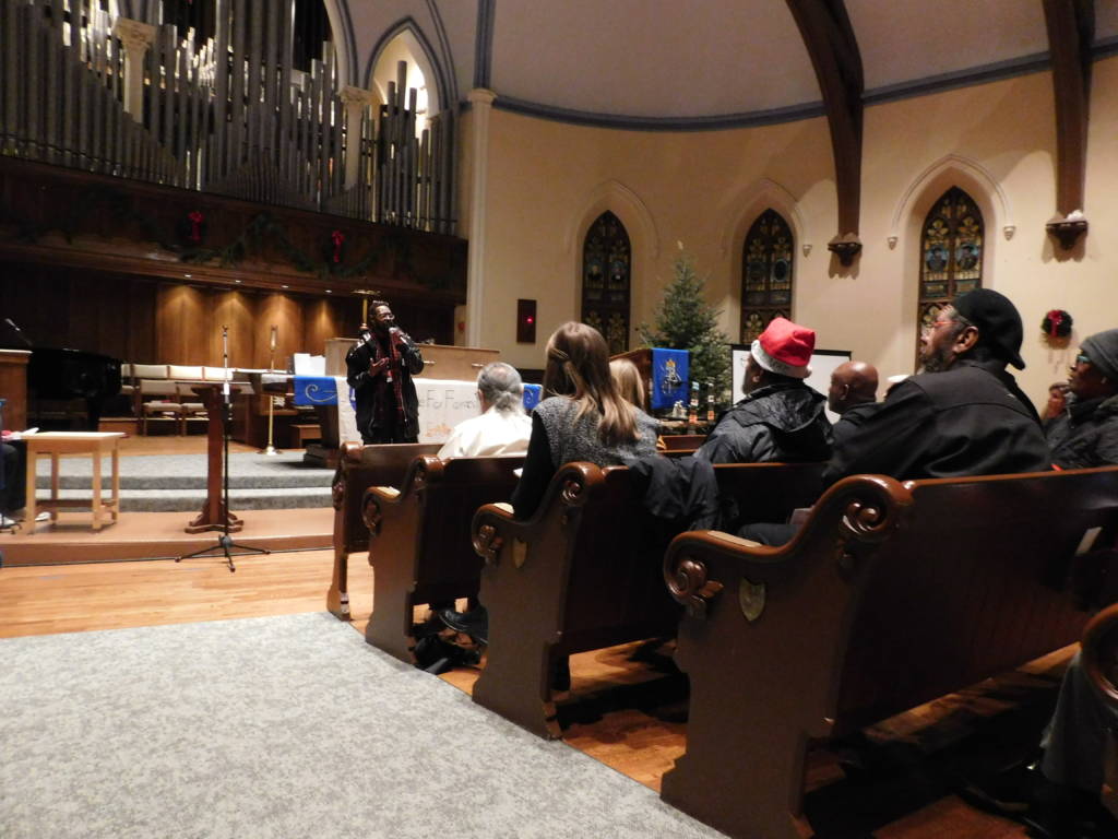 Photo of Reginald Black speaking to a crowd.