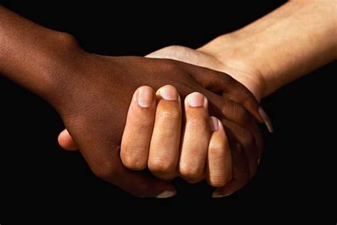 A photograph of people of different races holding hands.