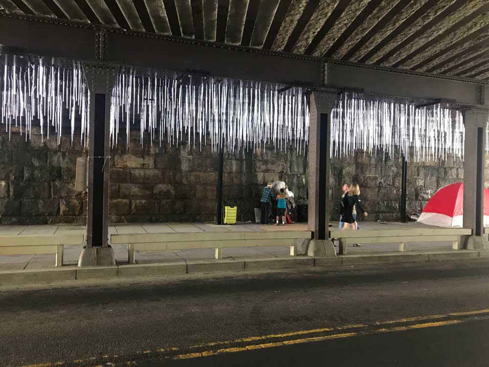 photo of a tent and the "rain" light art installation
