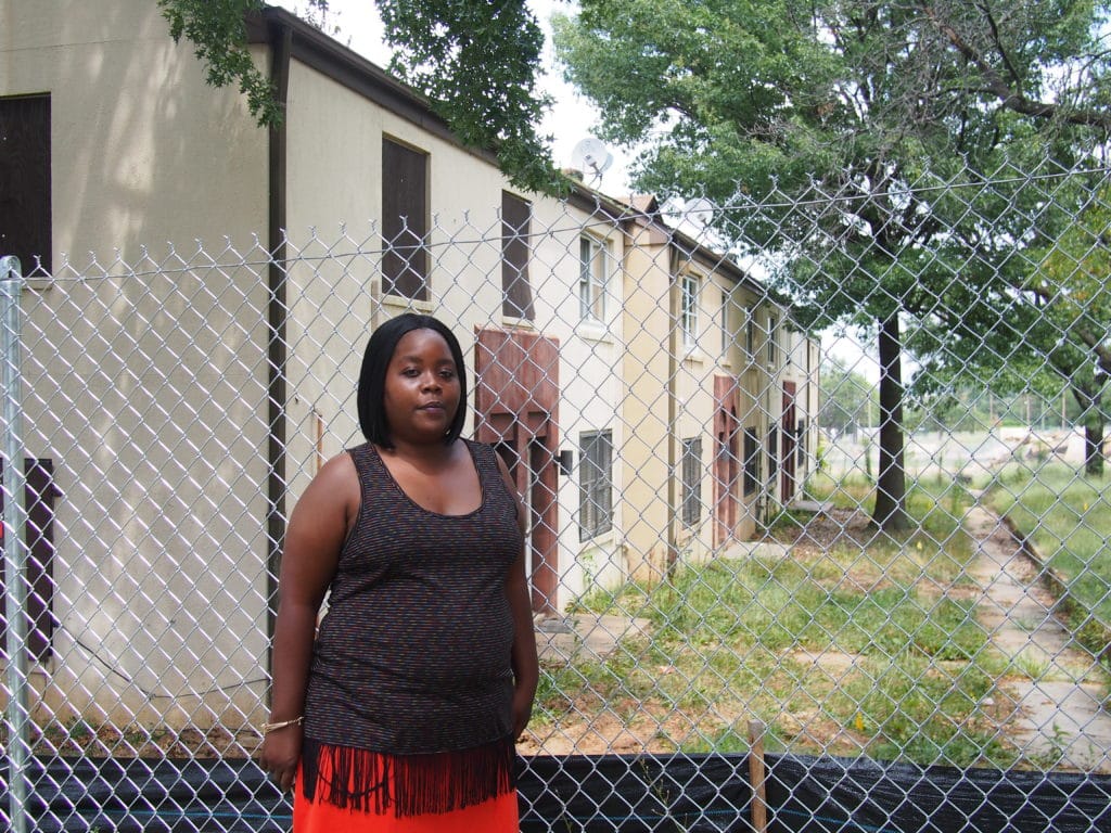 Picture of a woman in front of an old house