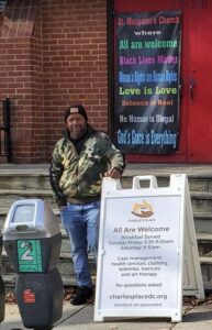An African-American man standing outside a church.