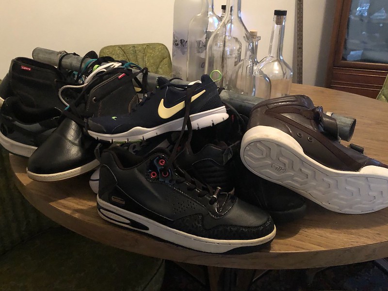 A photo of a collection of shoes sitting on a table.