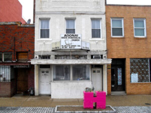 A white building stands on a city street