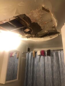 Photo of a hole in the ceiling of a Rapid Rehousing unit.