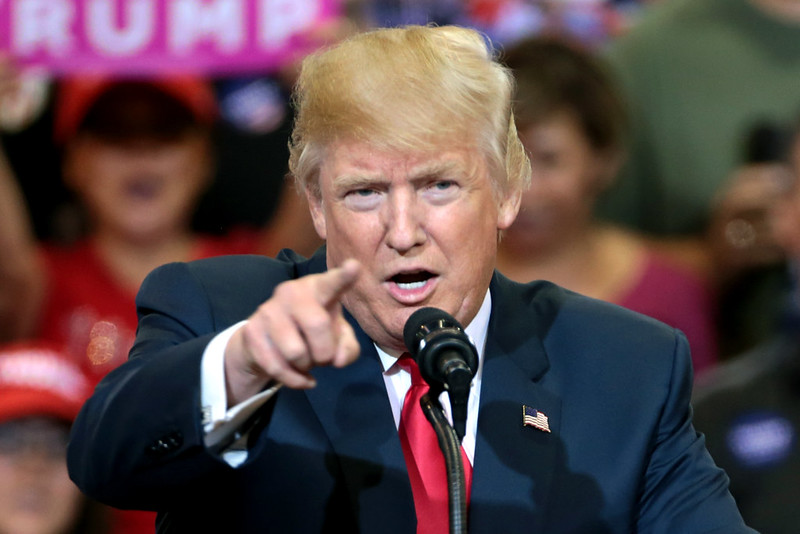 Photo of Donald Trump pointing as he is speaking with supporters at a campaign rally at the Phoenix Convention Center in Phoenix, Arizona.
