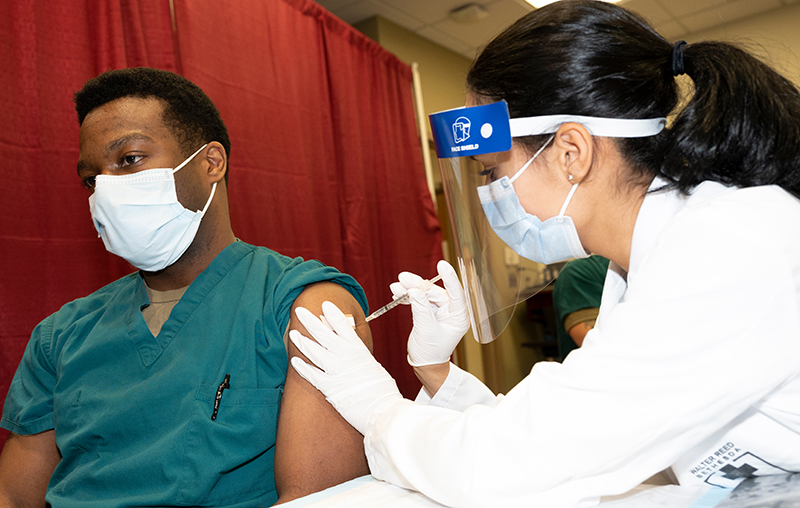 Photo of a man getting the COVID-19 vaccine