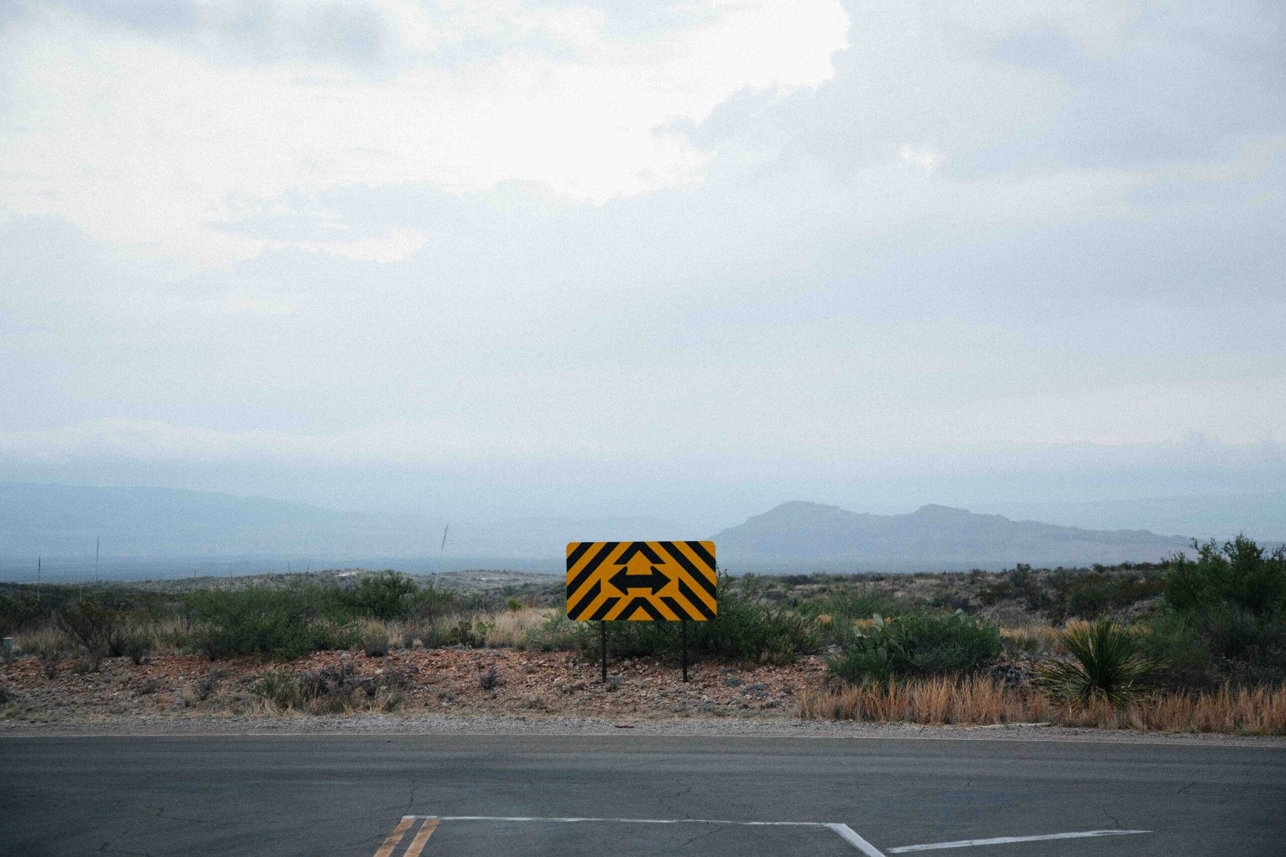 Intersection with a yellow sign displaying two directions