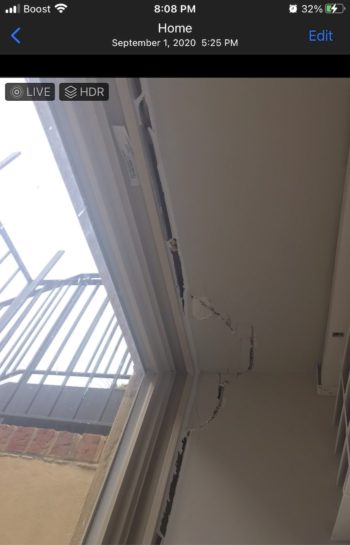 Photo of large cracks in the ceiling of a condo building.