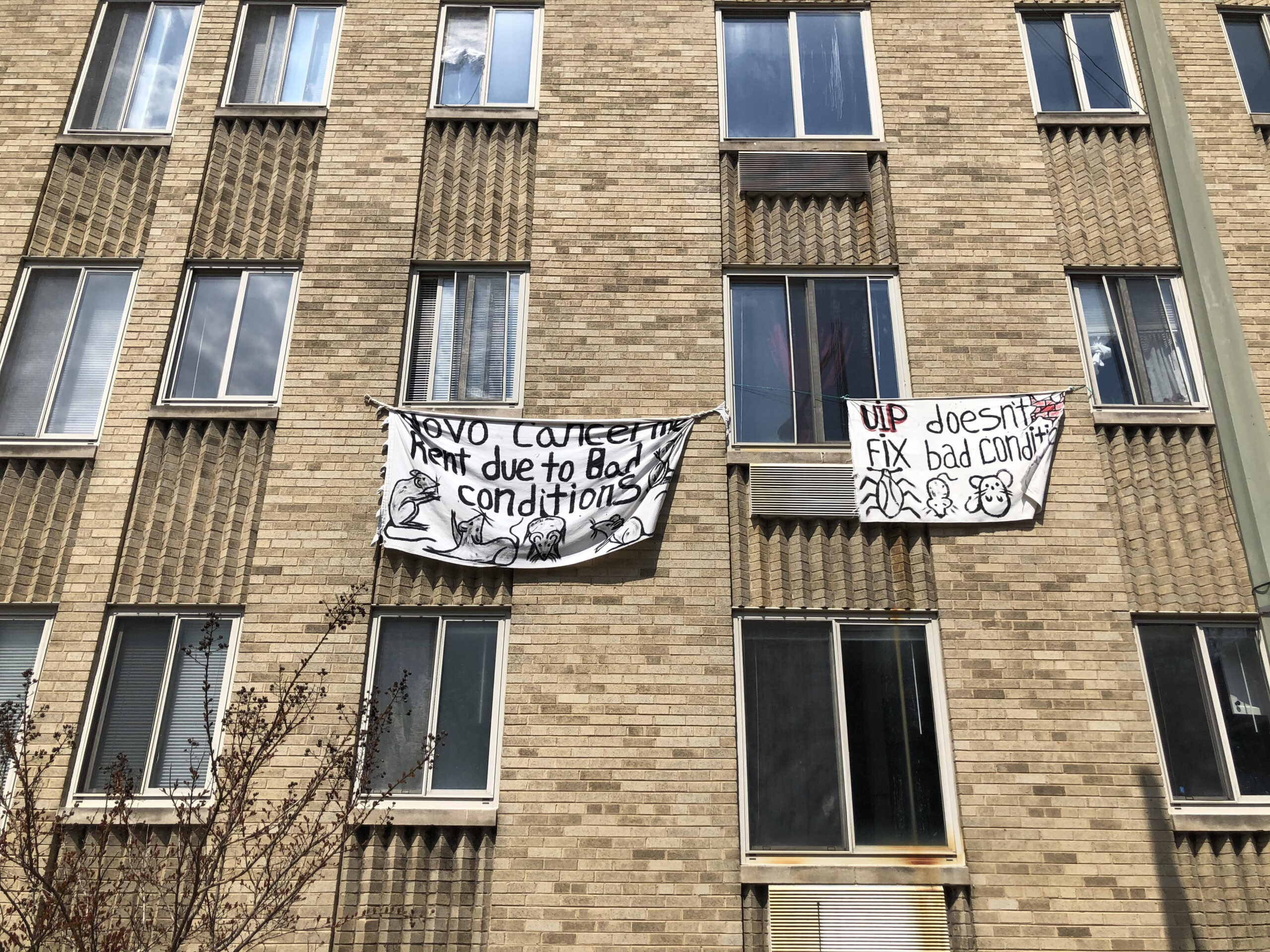 Photo of banners hanging outside of Meridian Heights Apartments