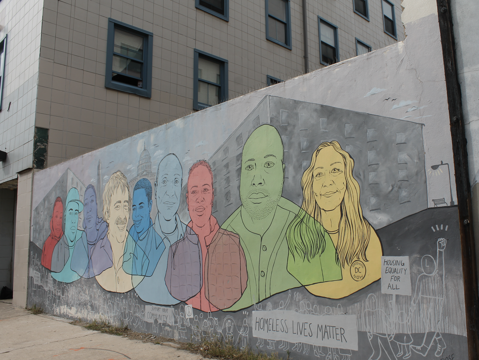 Photo shows the homeless lives matter mural at CCNV shelter, with colorful faces
