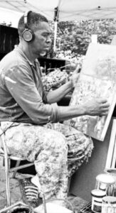 An artist paints at Eastern Market