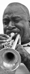 A musician plays a trumpet at Eastern Market