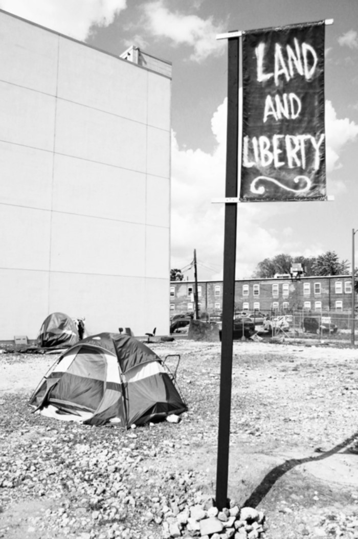 Photo of a tent and banner that says "Life and Liberty."