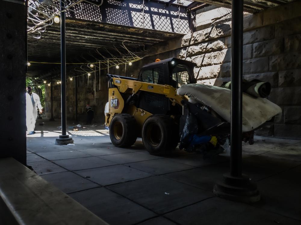 Photo of a machinery clearing out the encampment