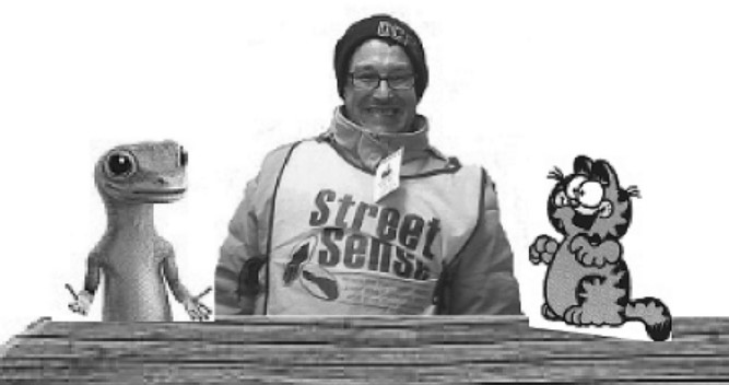 A photo of Garfield, the Geico Gecko, and Ken sitting at a wooden table.