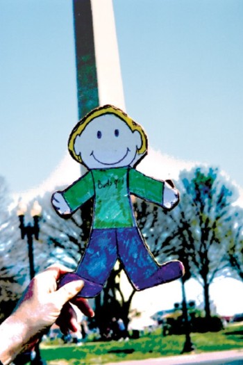 Photo of Ken's flat Caryn doll held in front of the Washington Monument