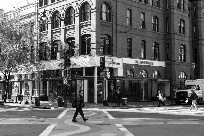 A black and white photo of a Barnes Dance crossing in Chinatown, DC. Only a few people are visible.