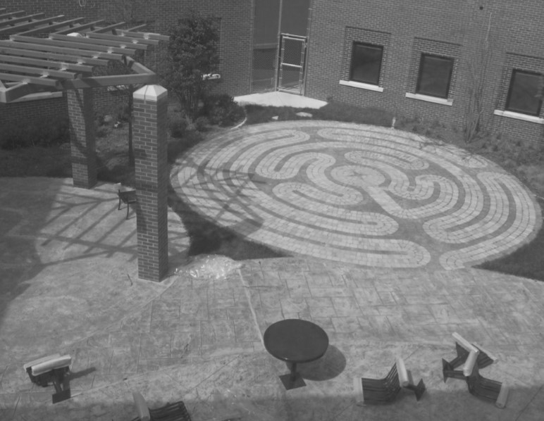 The plaza in the photo depicts a maze on the ground