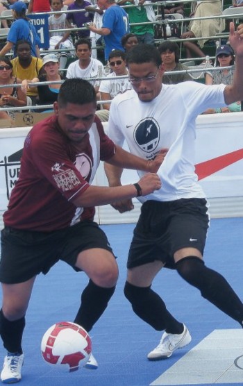 Two players battle over the soccer ball