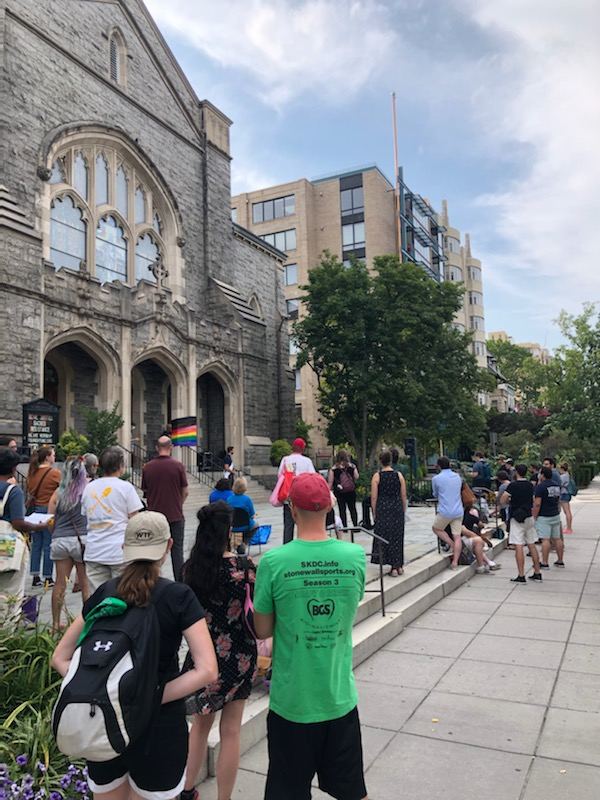 A photo from behind the crowd gathered to pay respect to the lives lost
