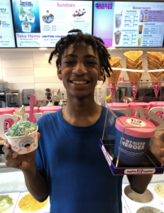Photo of Miguel Coppedge holding up ice cream in Baskin-Robbins.