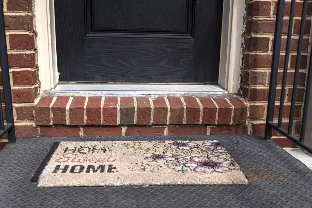 A doormat outside a home that says "home sweet home"